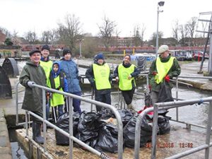 Litter pickers on the Foss Barge